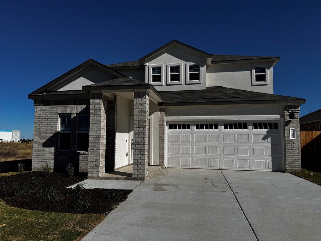 a front view of a house with a garage