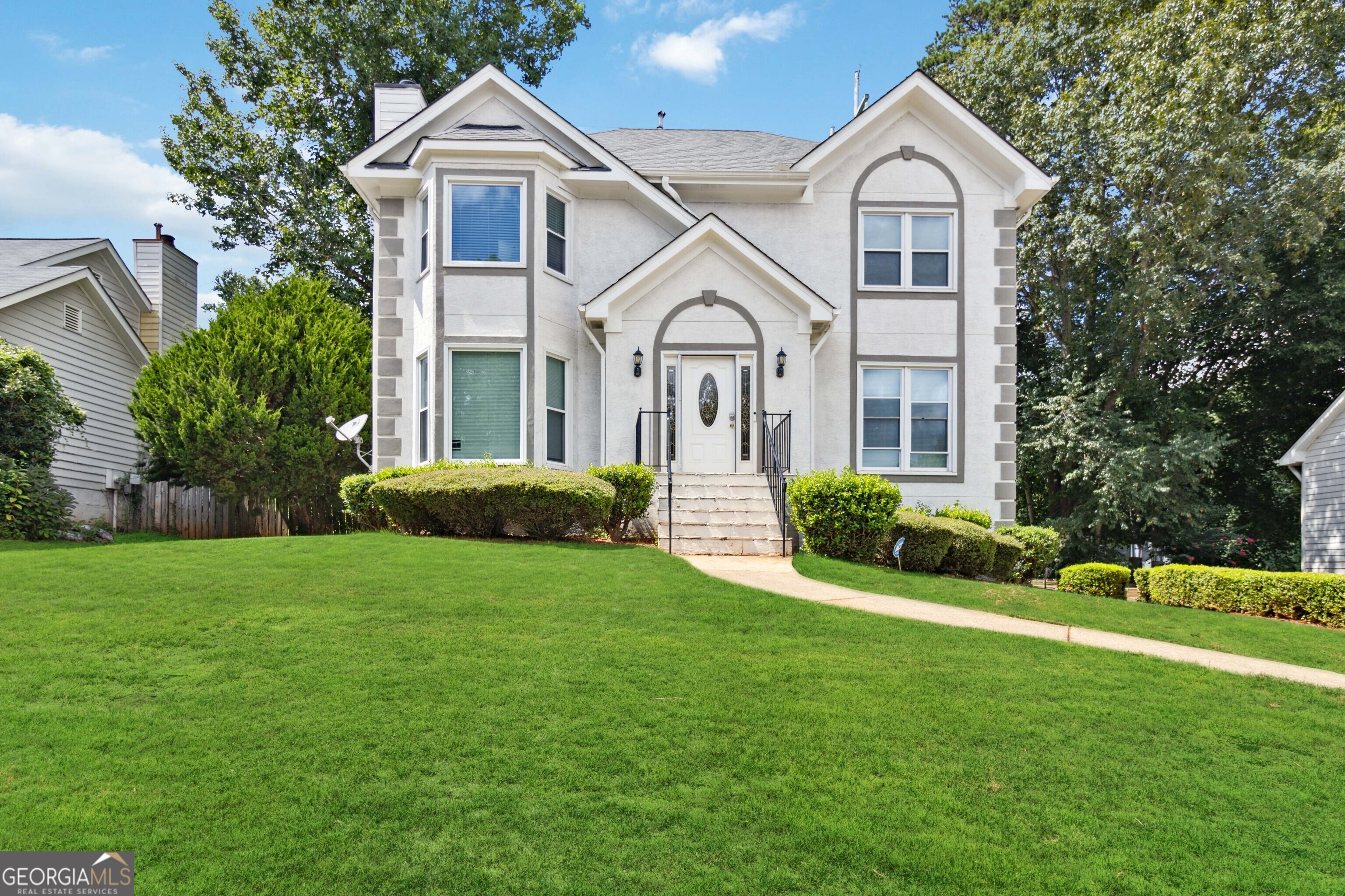 a front view of a house with a yard and garage