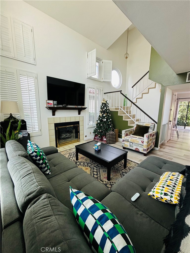 a living room with furniture a flat screen tv and a fireplace