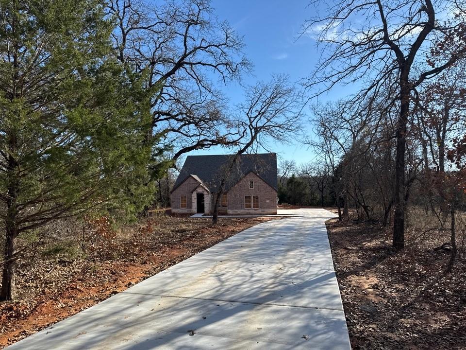 a view of a backyard with large trees