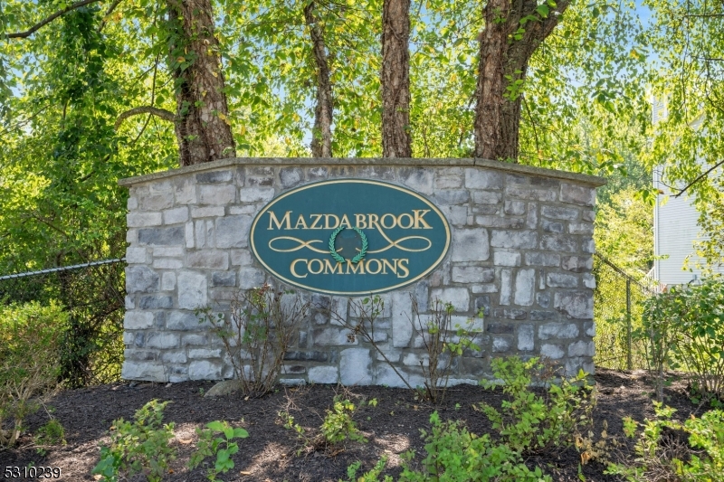 a sign board with a tree in the background