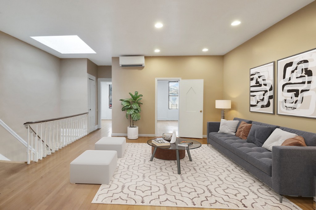 a living room with furniture and a potted plant