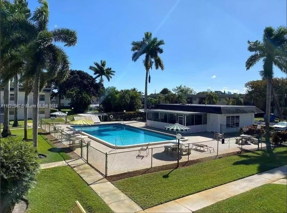 a view of a swimming pool with chairs