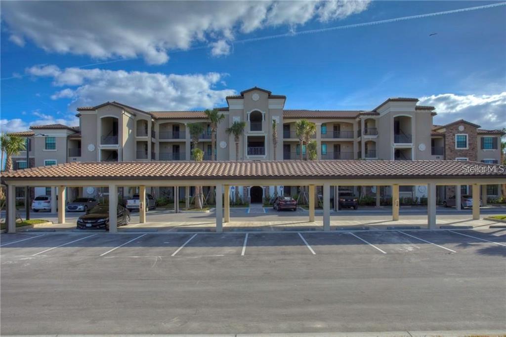 a front view of a building and car parked