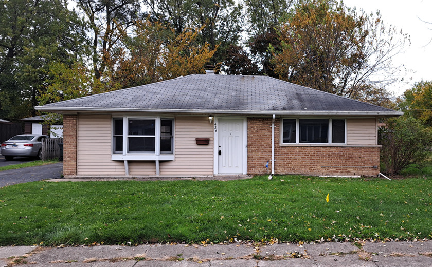 a front view of a house with a garden