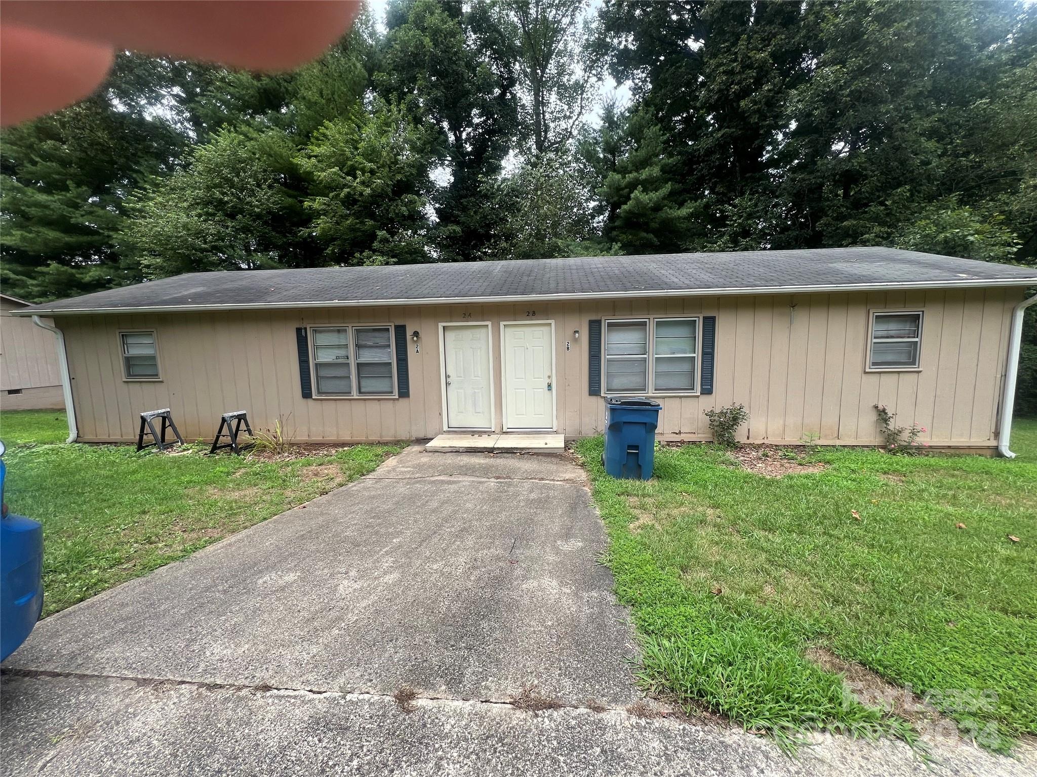 a front view of house with a garden