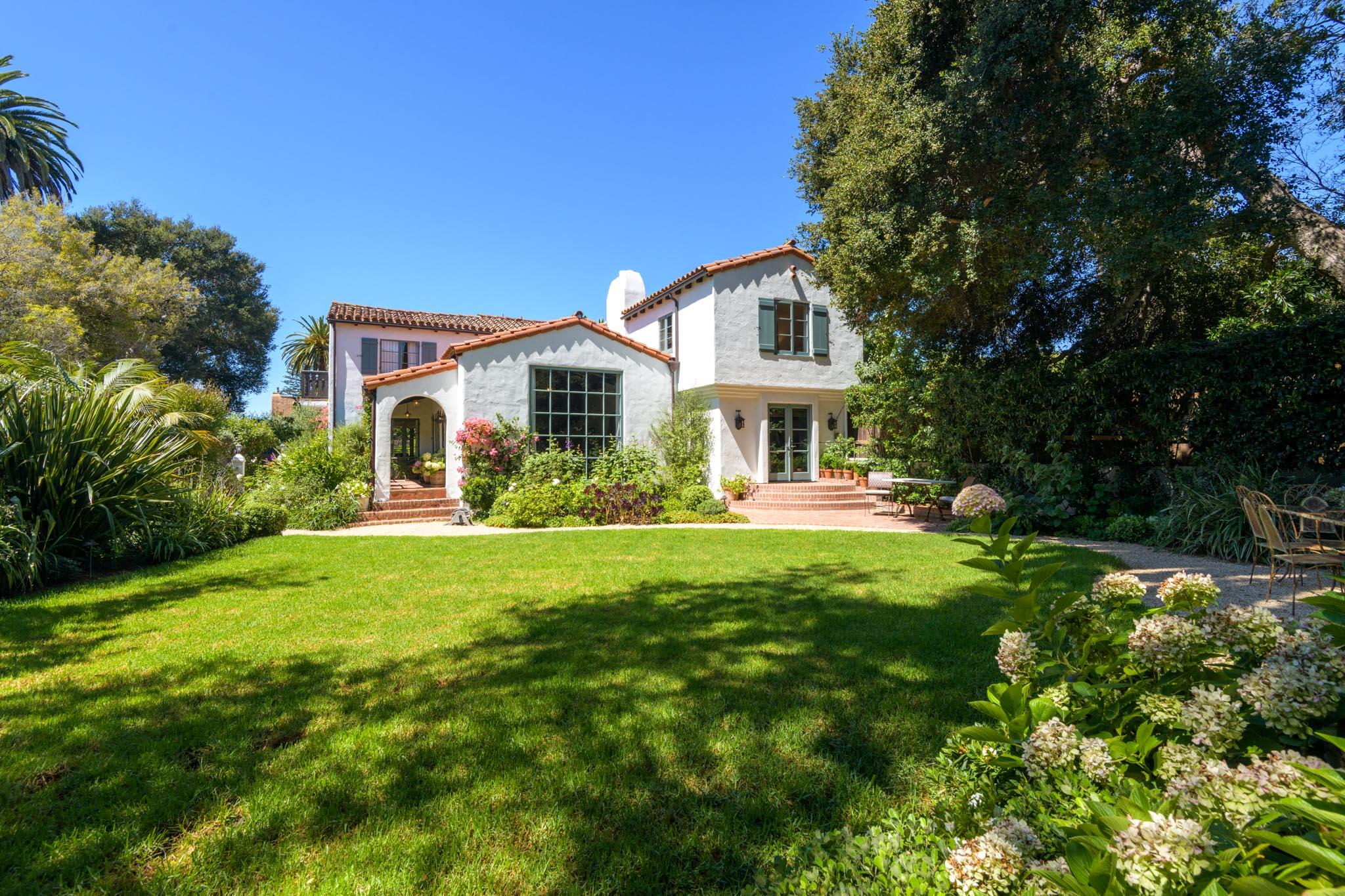 a front view of a house with yard and green space