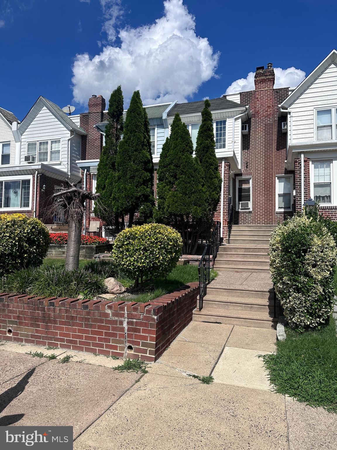 a front view of a house with a garden