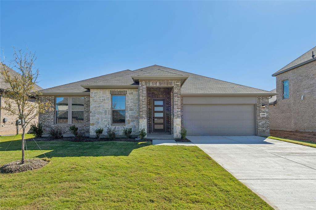 a front view of a house with a yard and garage