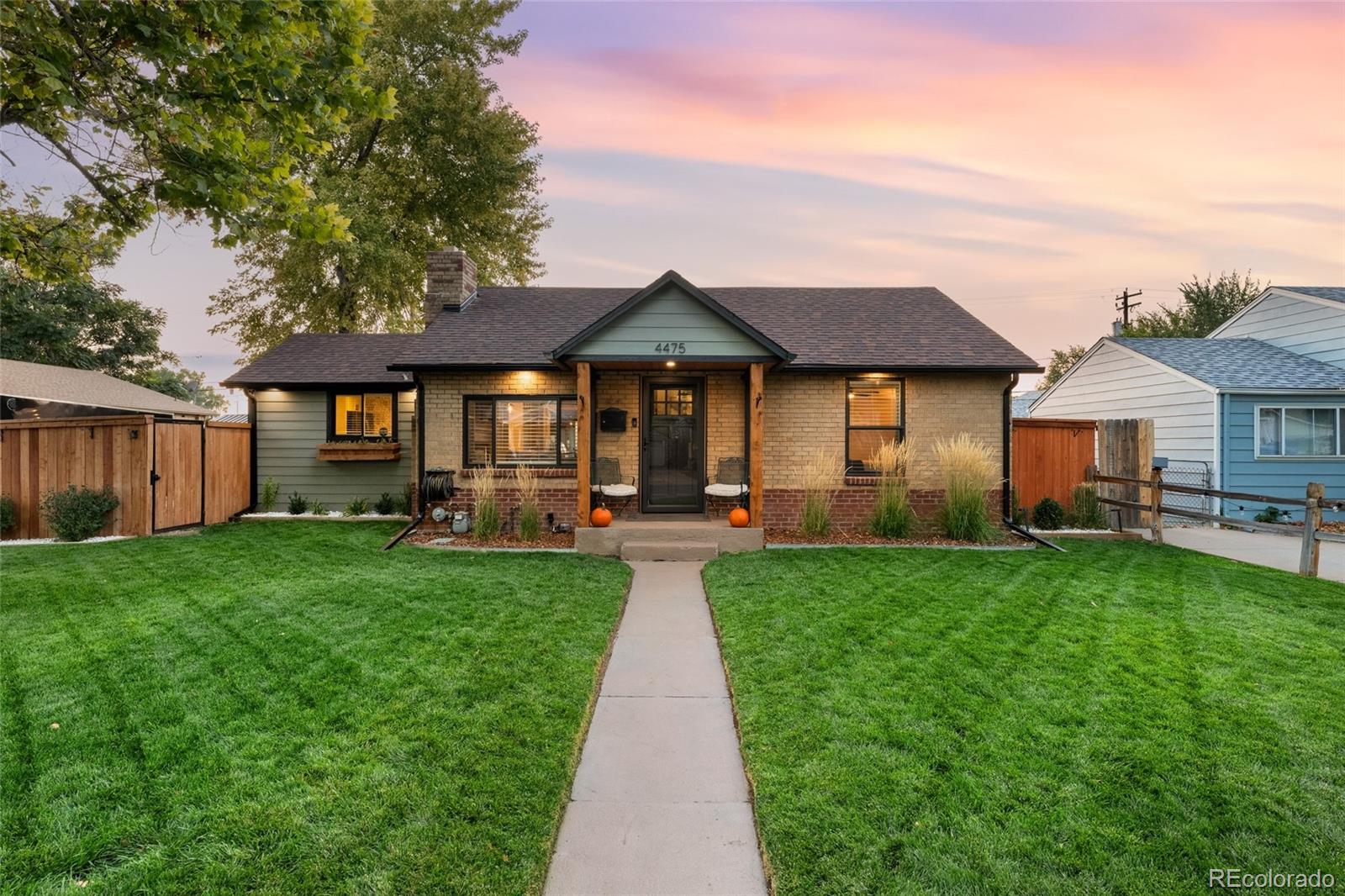 a front view of a house with yard patio and green space