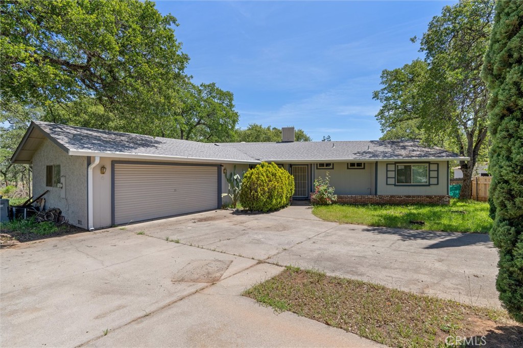 a front view of a house with a yard and a garage