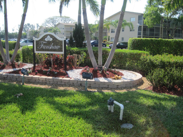 a view of a multi story building with a yard