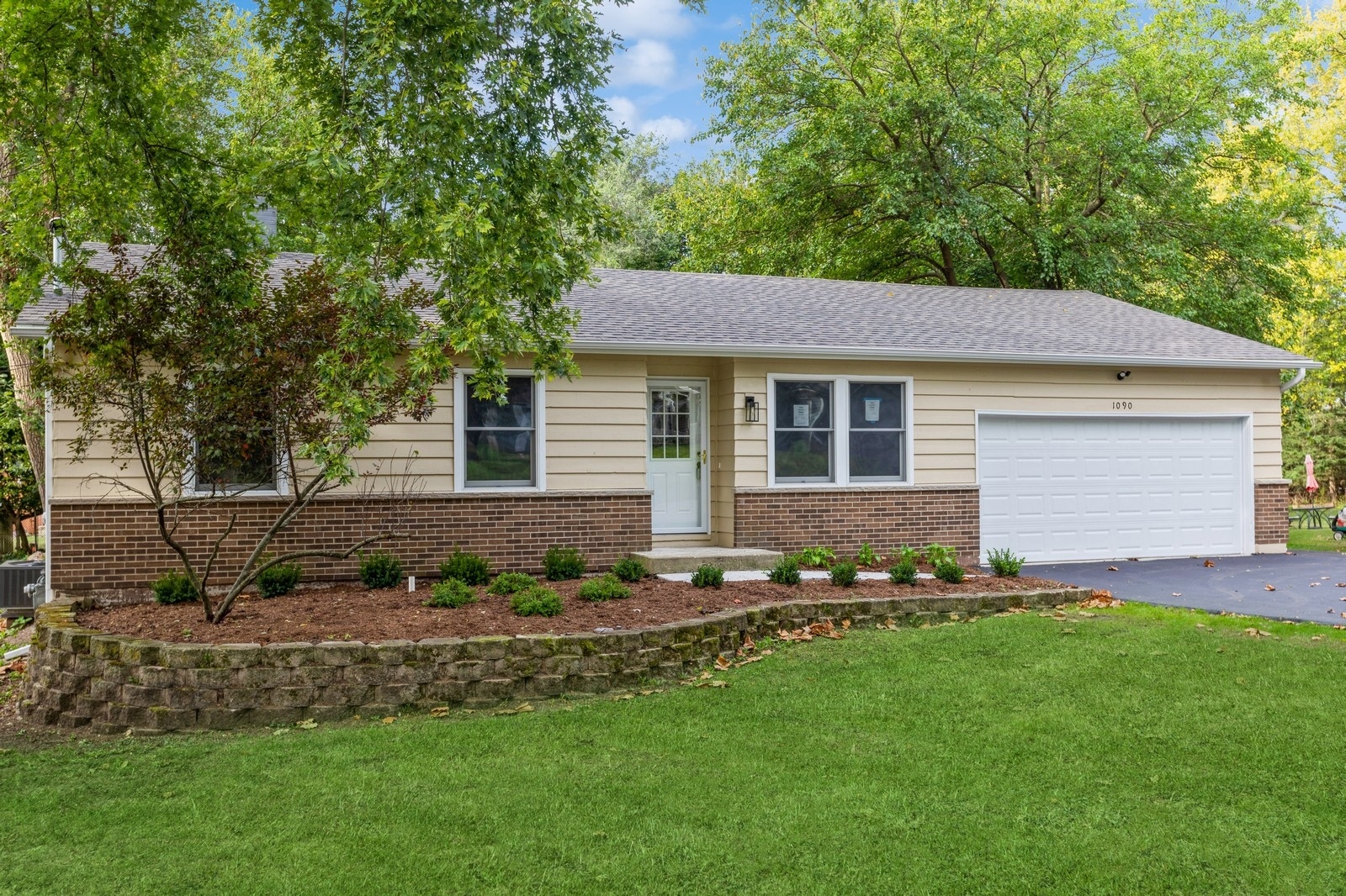 a front view of a house with a garden