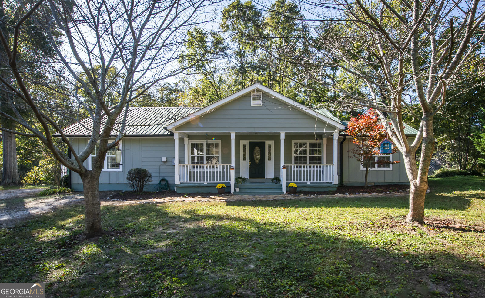 a front view of a house with yard and green space