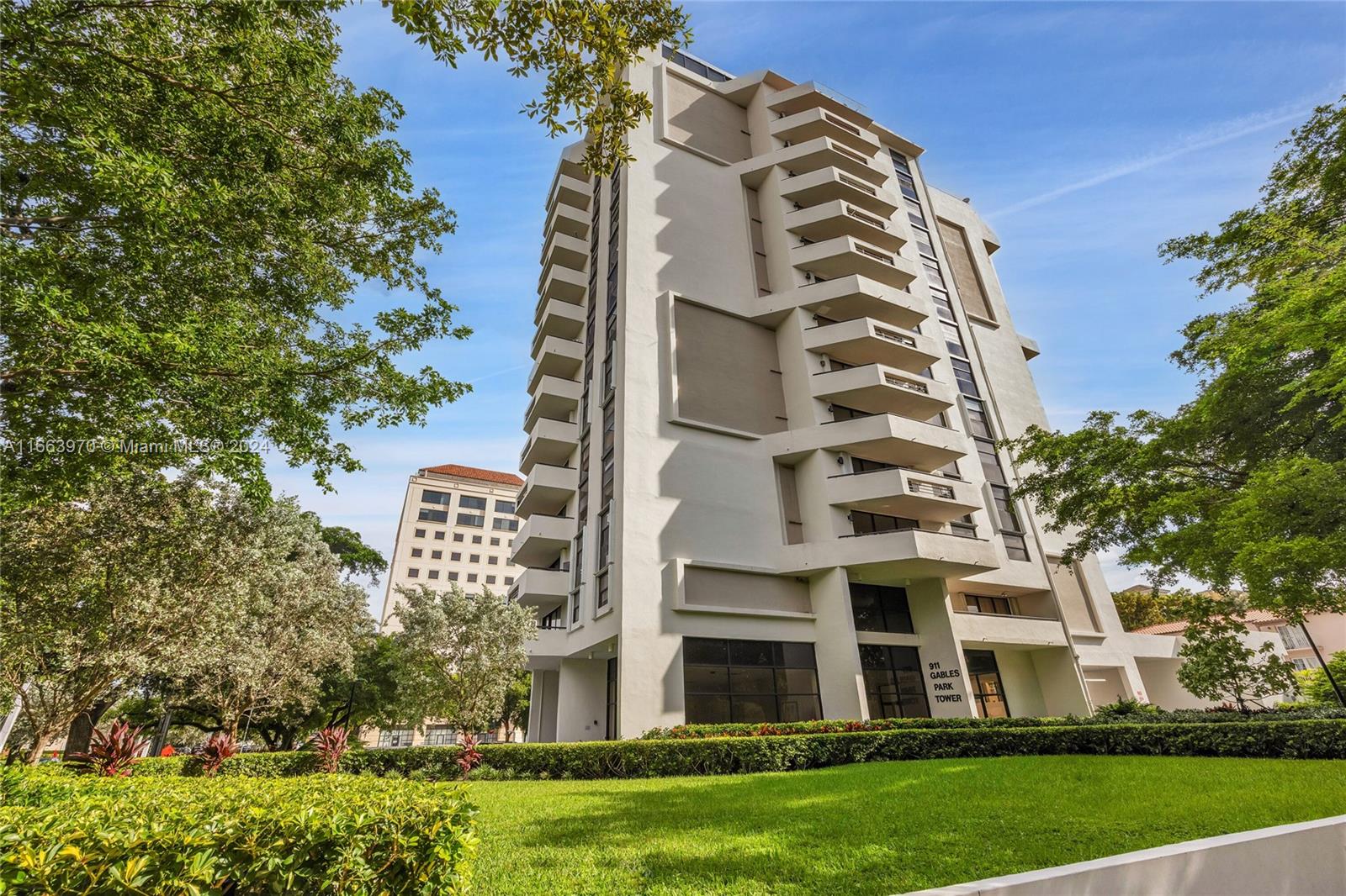 a view of a tall building next to a yard