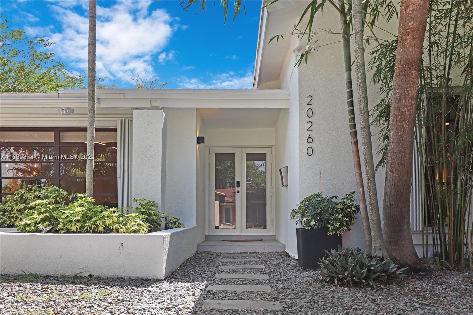 front view of a house with a potted plant