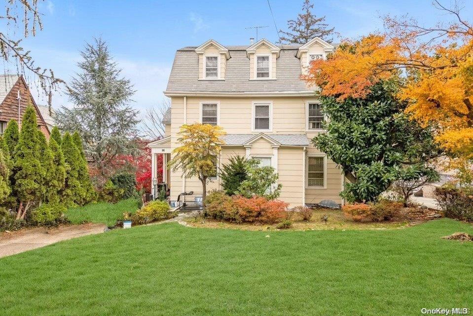 a front view of house with yard and green space