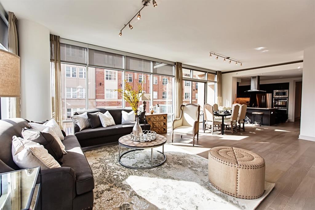 a living room with furniture and large windows