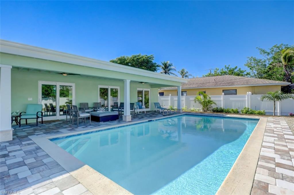 a view of a house with swimming pool and sitting area