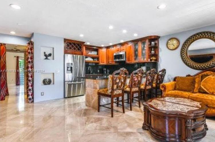 a living room with furniture a rug and a large window