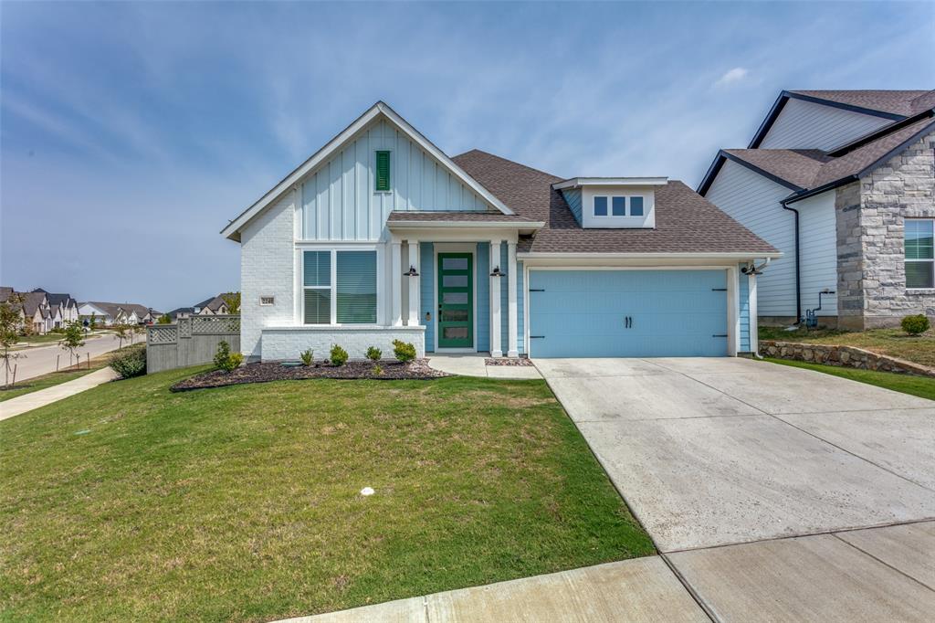 a view of a house with a yard and garage