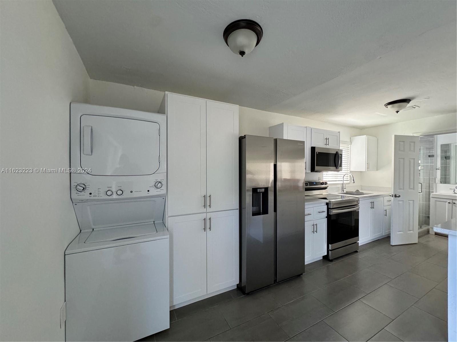 a kitchen with stainless steel appliances a refrigerator sink and stove