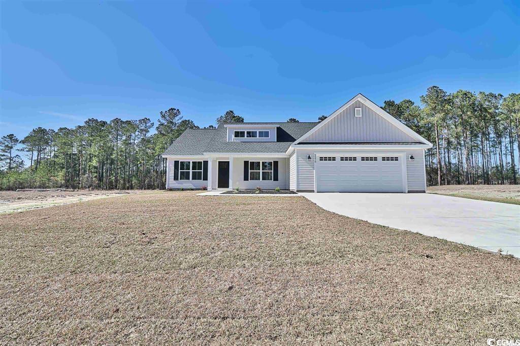 View of front of property featuring a garage and a