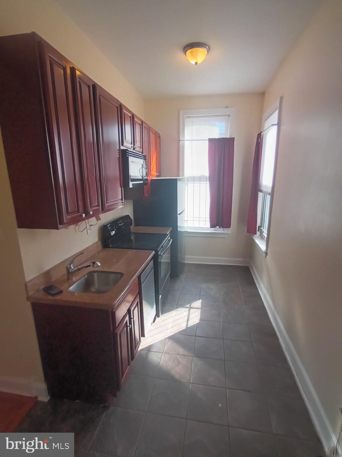 a kitchen with stainless steel appliances granite countertop a sink stove and a refrigerator