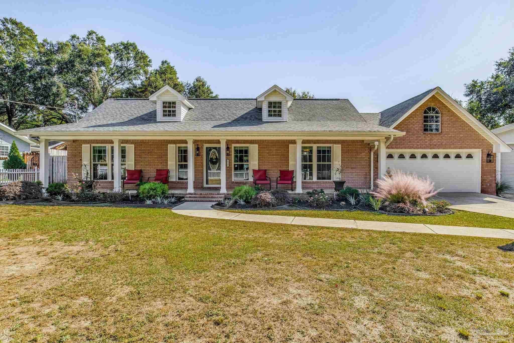 a front view of a house with garden