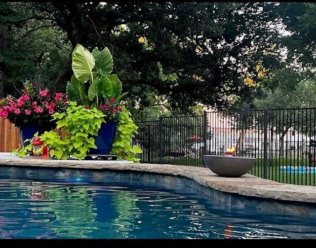 a view of swimming pool with a back yard