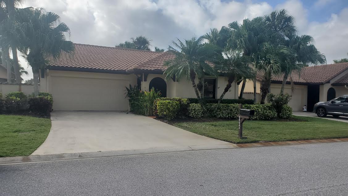 a view of a house with a yard and garage