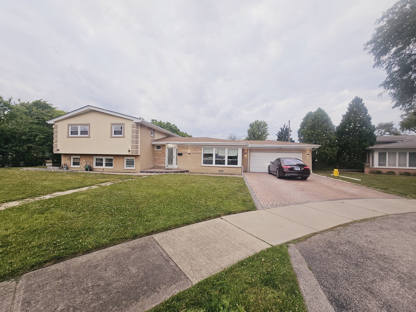 a front view of a house with a garden and yard