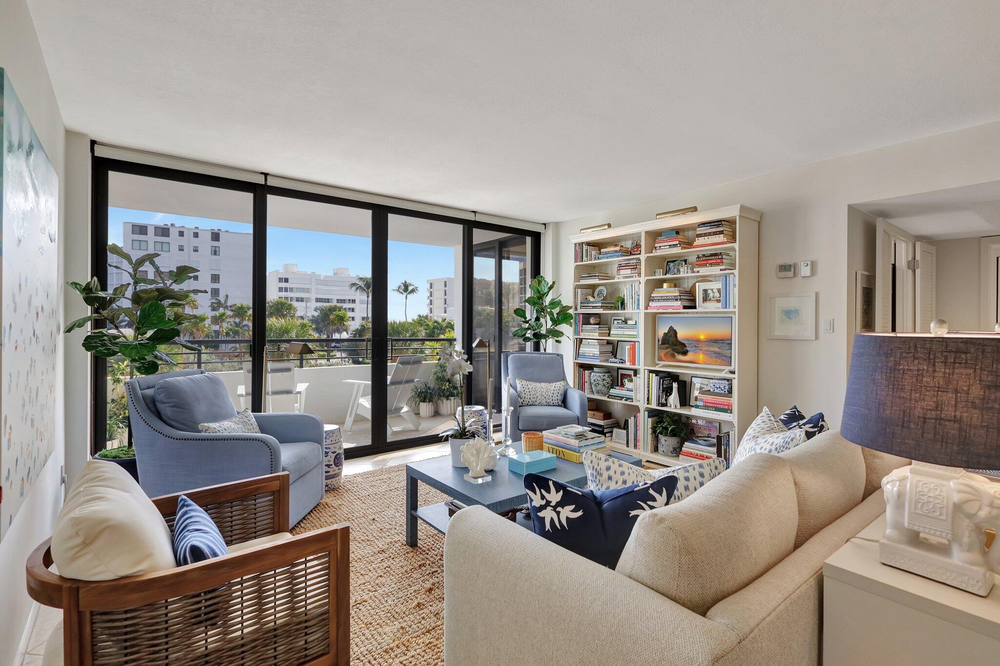 a living room with furniture and a floor to ceiling window