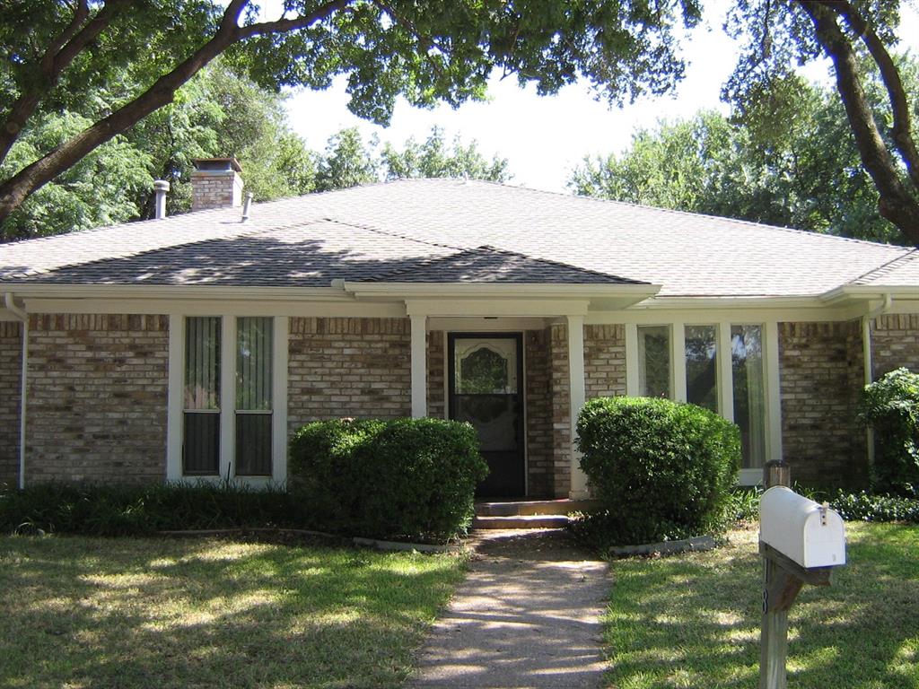 a front view of a house with a garden and porch