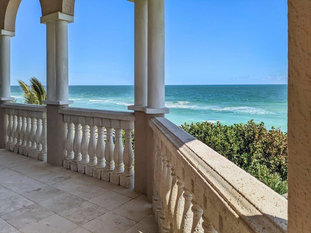 a view of a balcony with ocean view