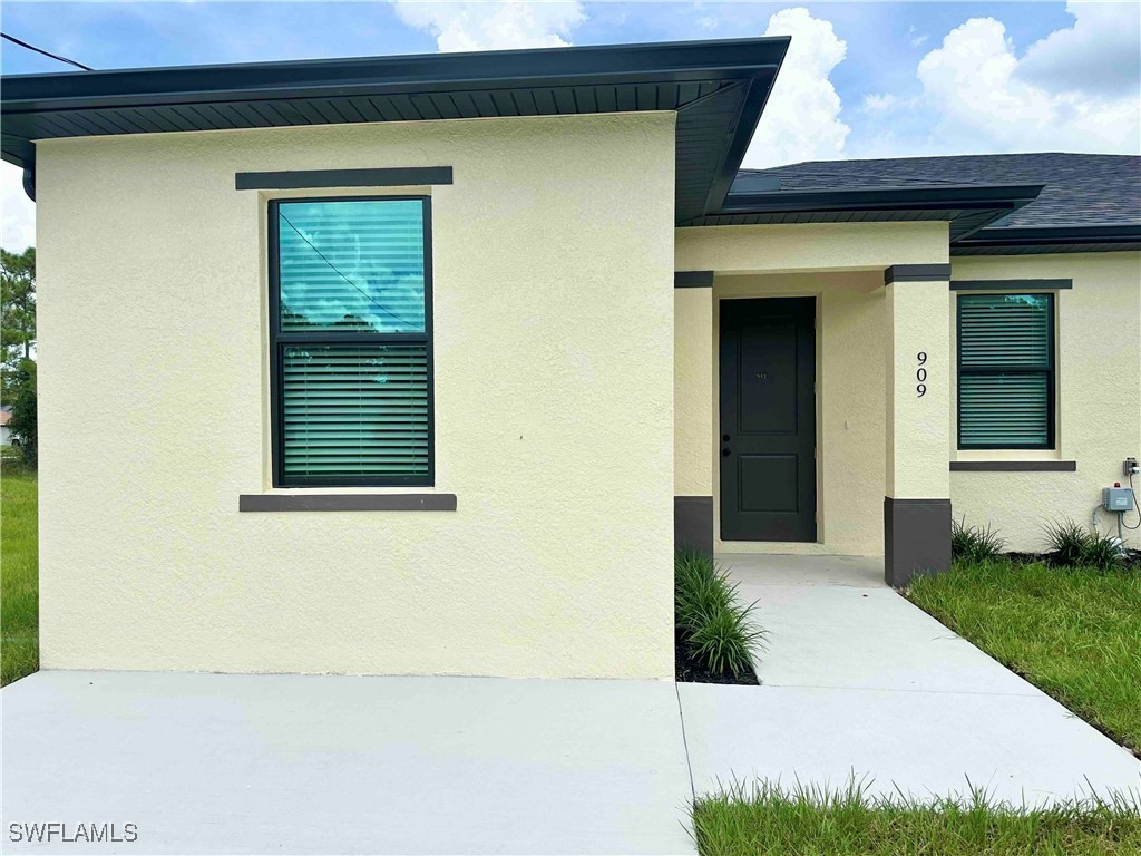 a view of a house with a small yard