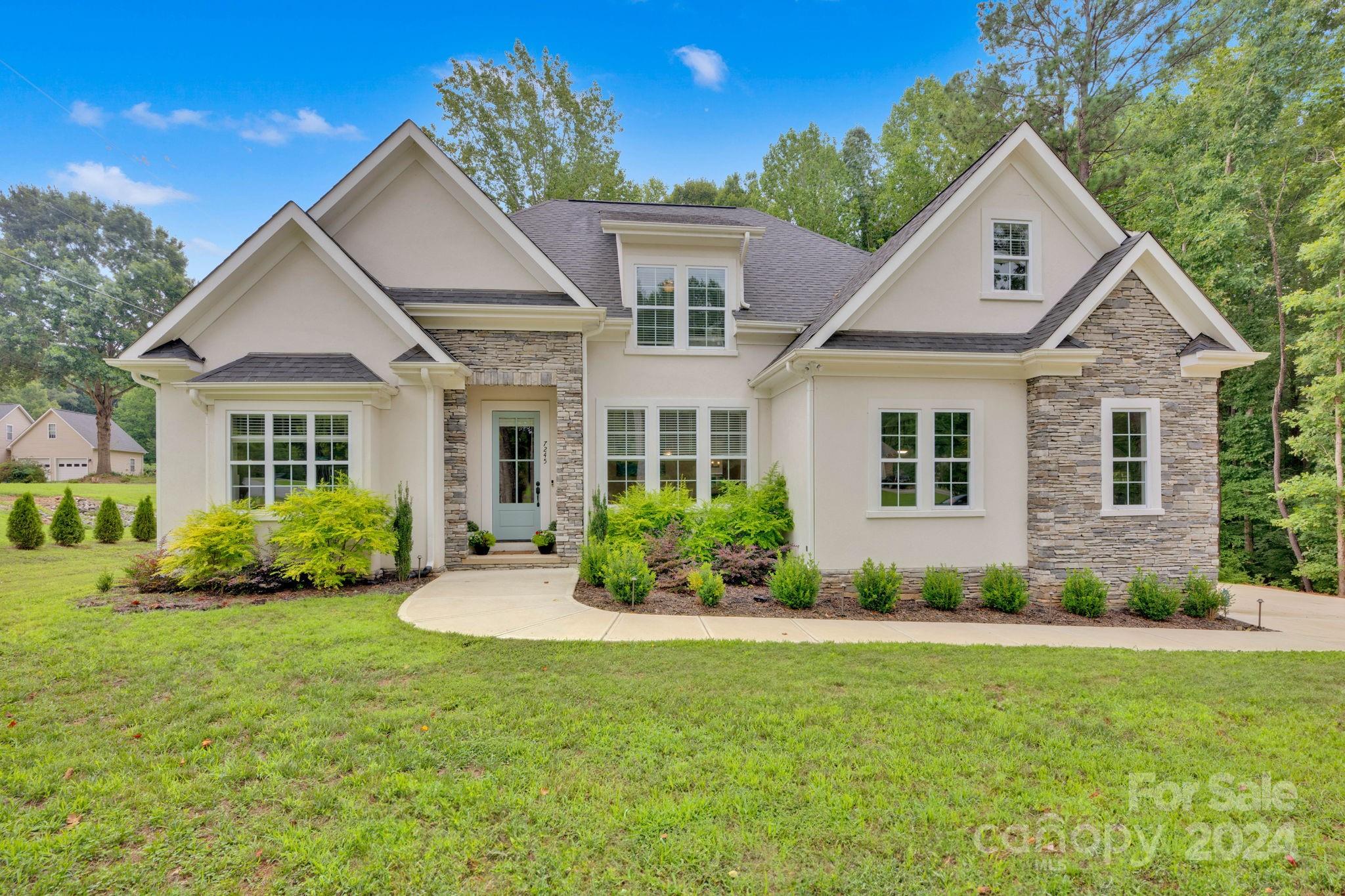 a front view of a house with a yard and porch