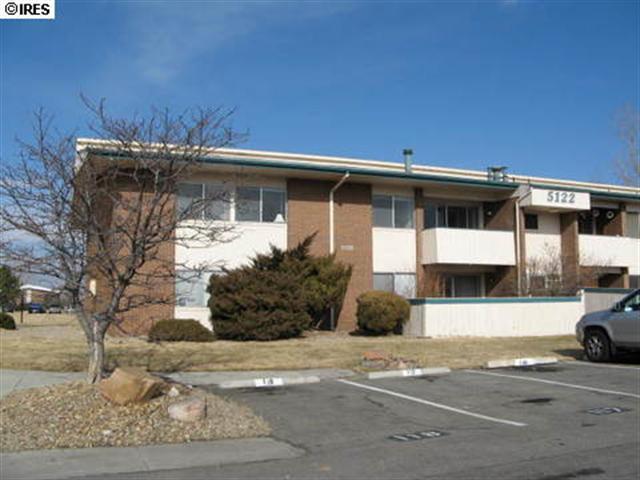 a view of a car park front of a house