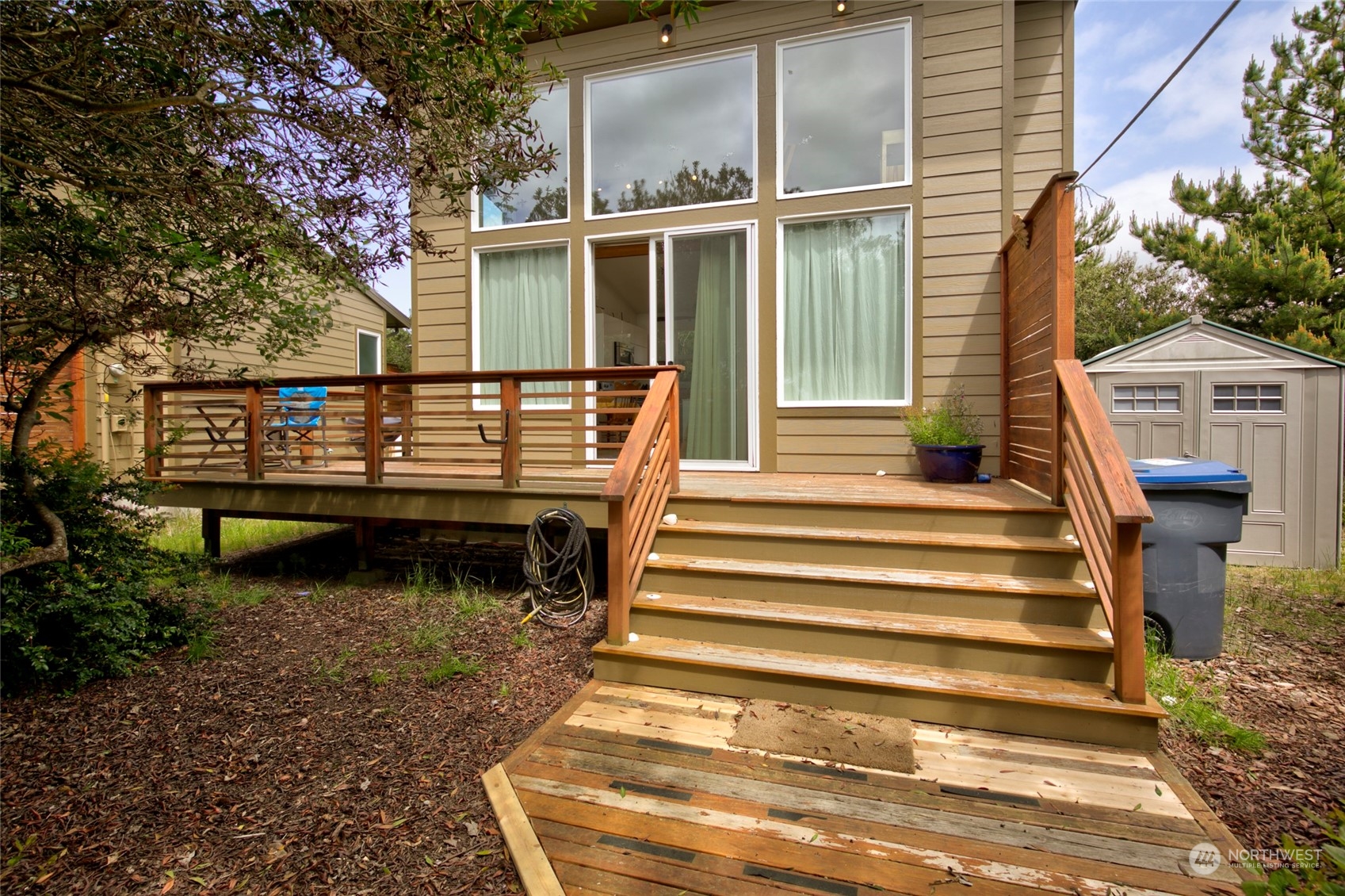 a view of a wooden deck and a yard