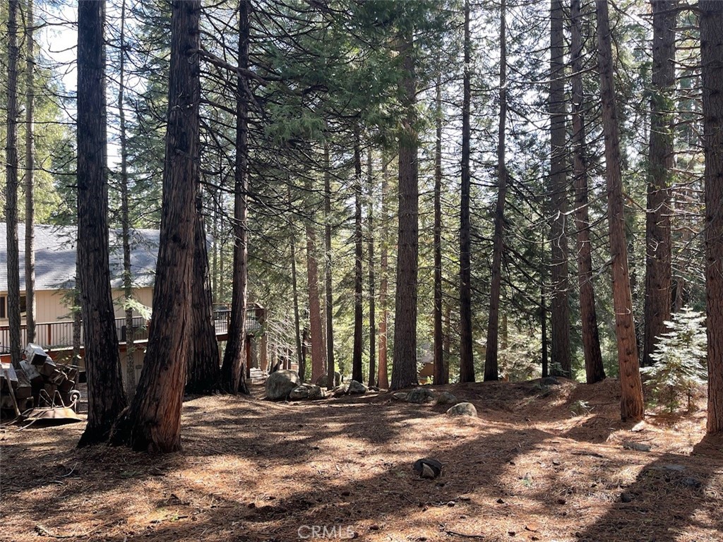 a view of a house with trees in the background