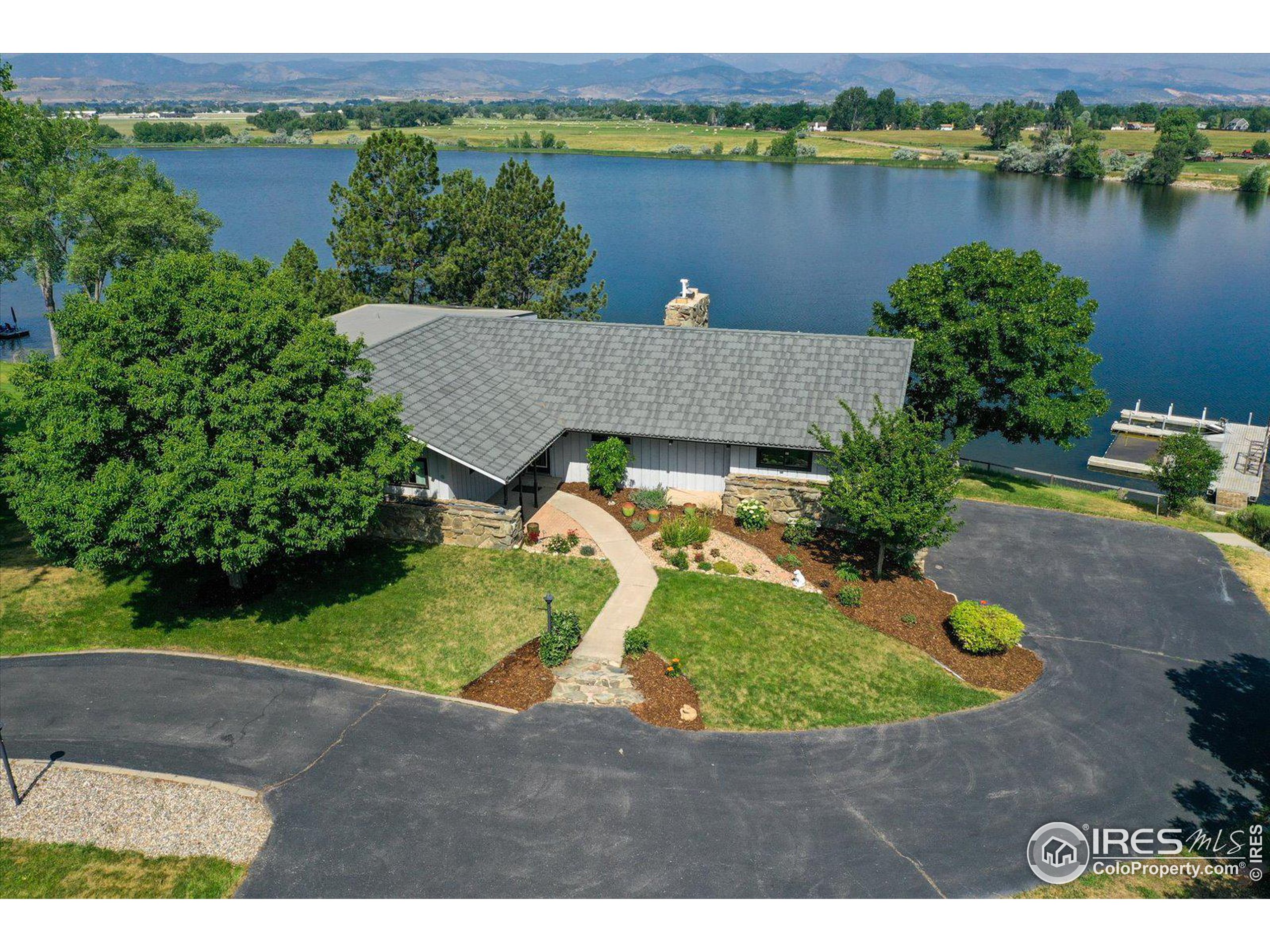 an aerial view of a house with a lake view