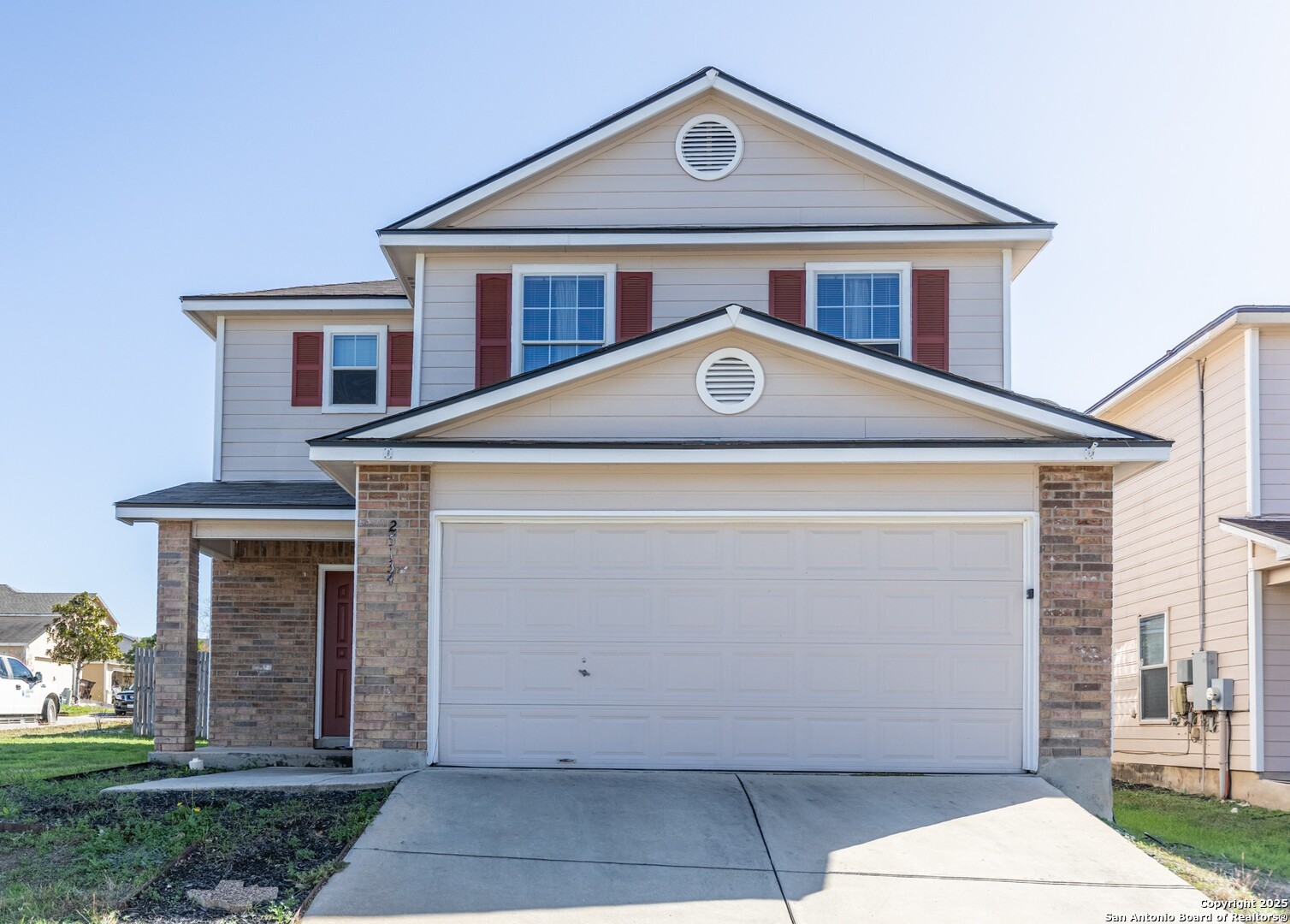 a front view of a house with a yard