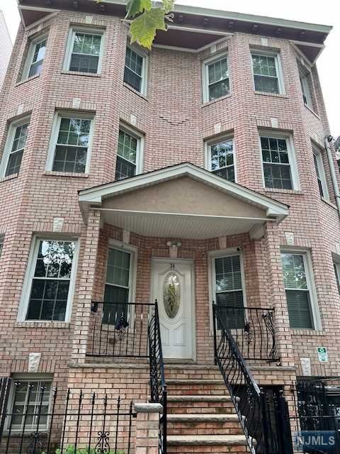 a front view of a house with many windows