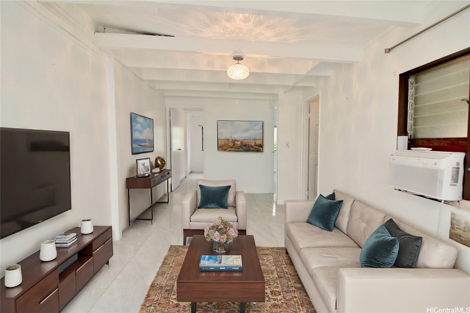 a living room with furniture and a flat screen tv