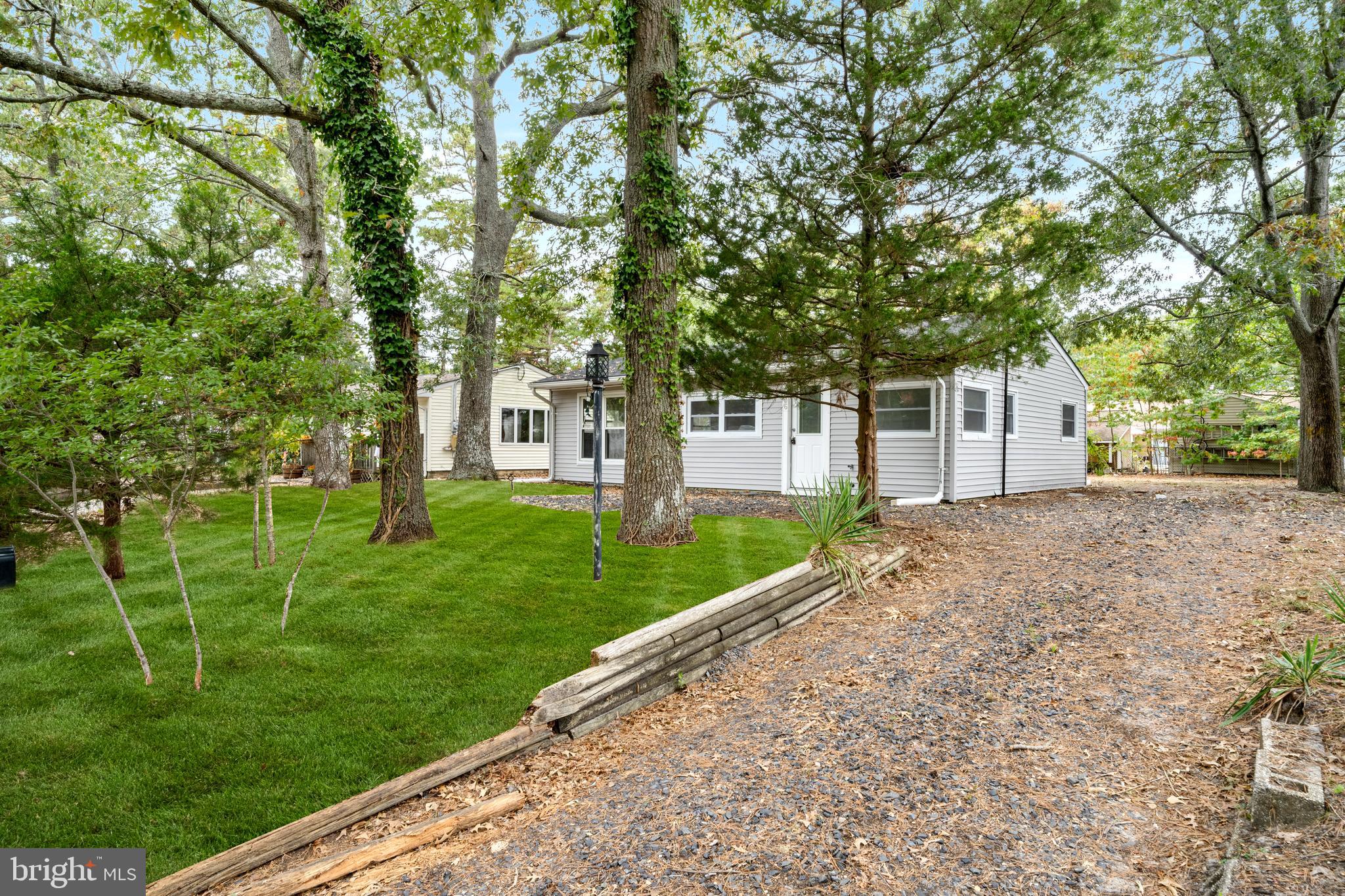 a view of a house with backyard and a tree