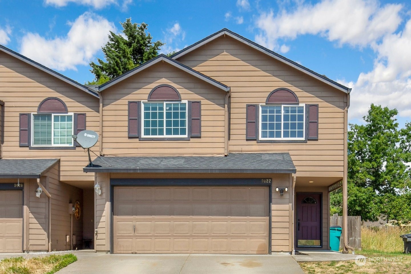 a front view of a house with a garage