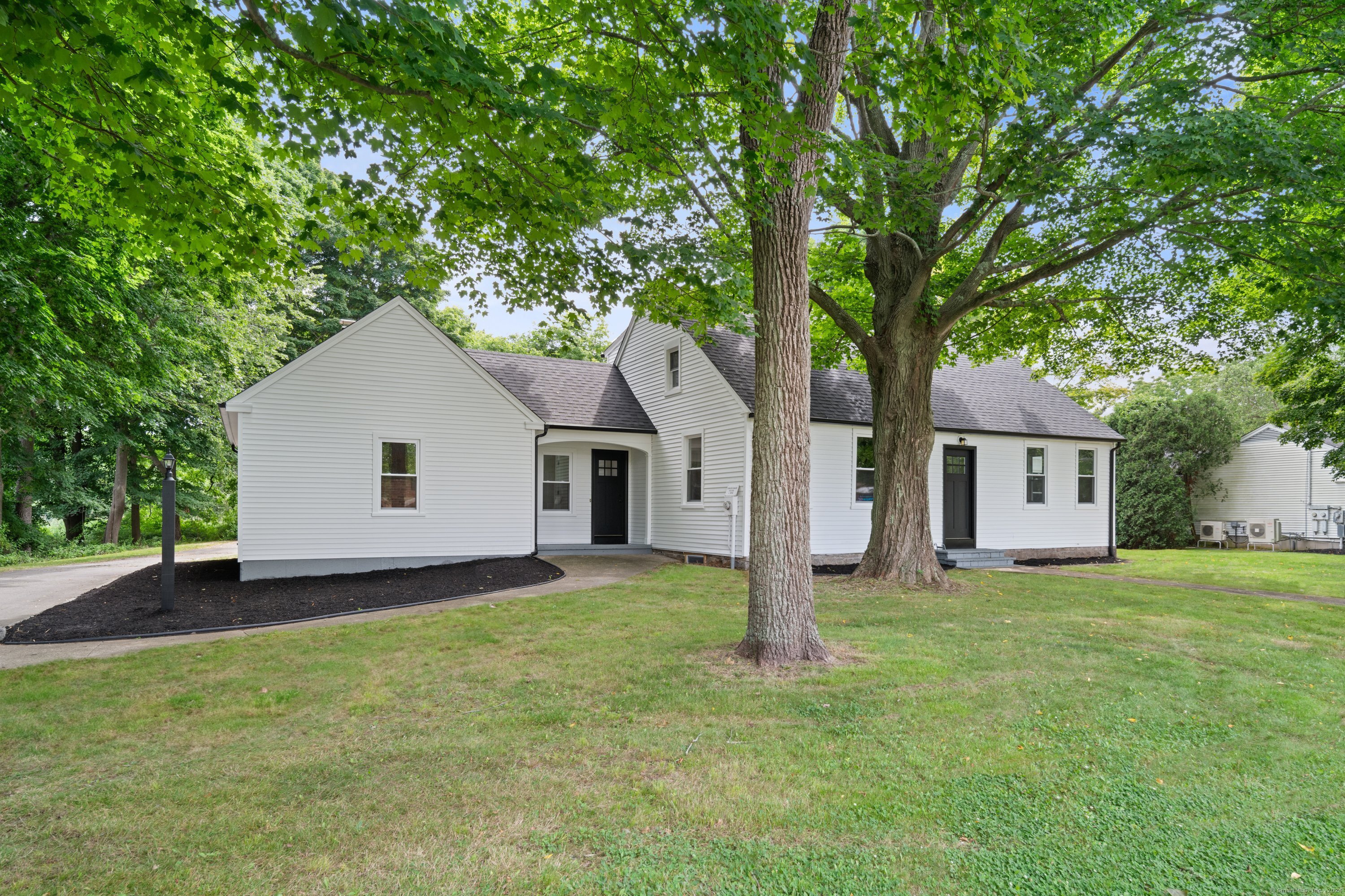 a house that has a tree in front of the house