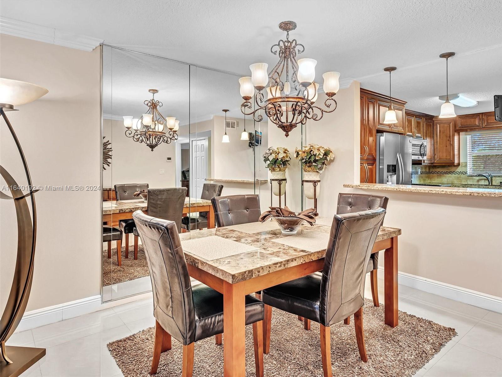 a view of a dining room with furniture a chandelier and wooden floor