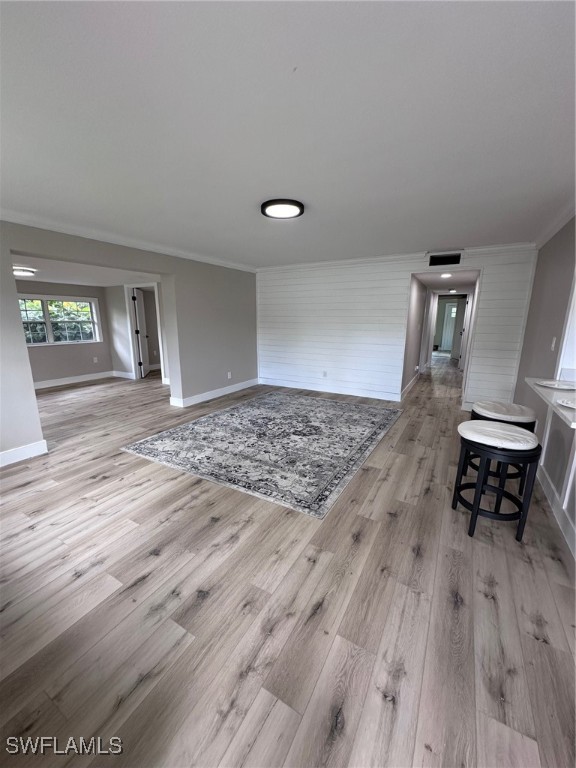 a view of a room with wooden floor and a sink