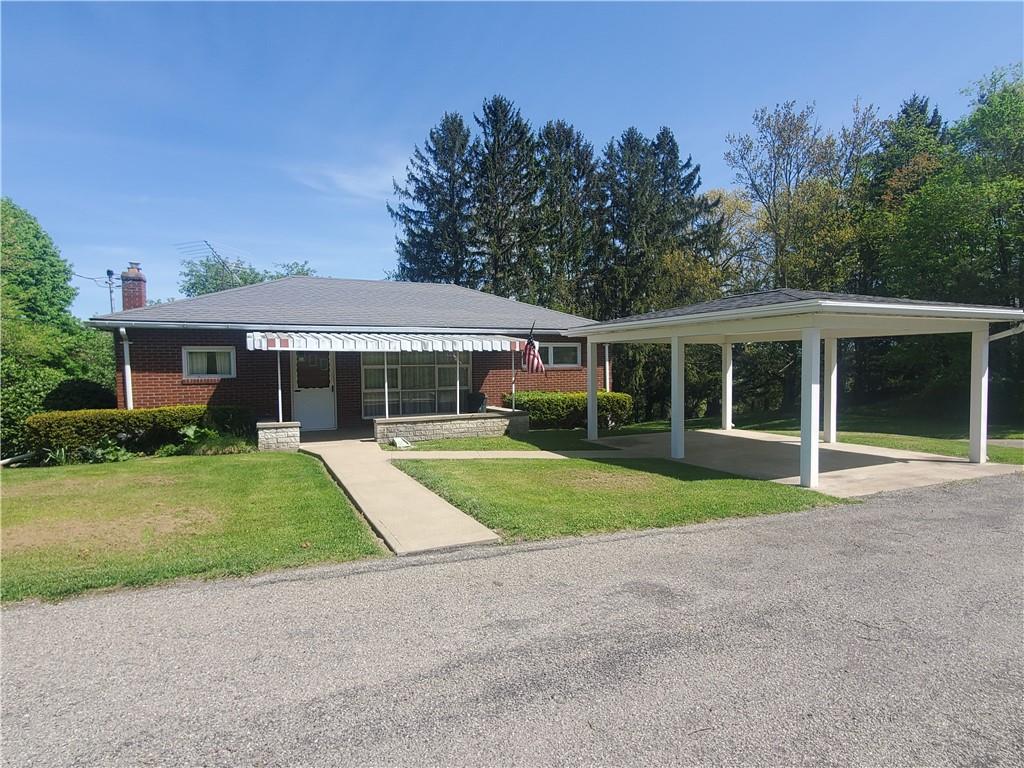 a view of house with outdoor space and garden